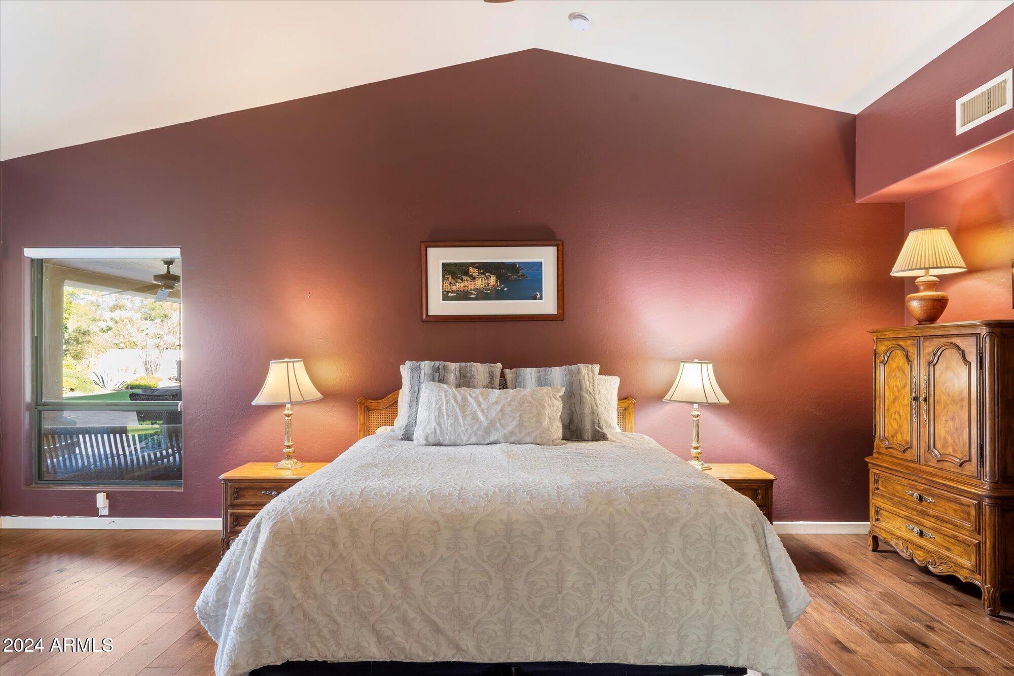 25255 North Ranch Gate Road Scottsdale, AZ 85255 - Photo 26 of 68 a bedroom with a bed and wooden floor