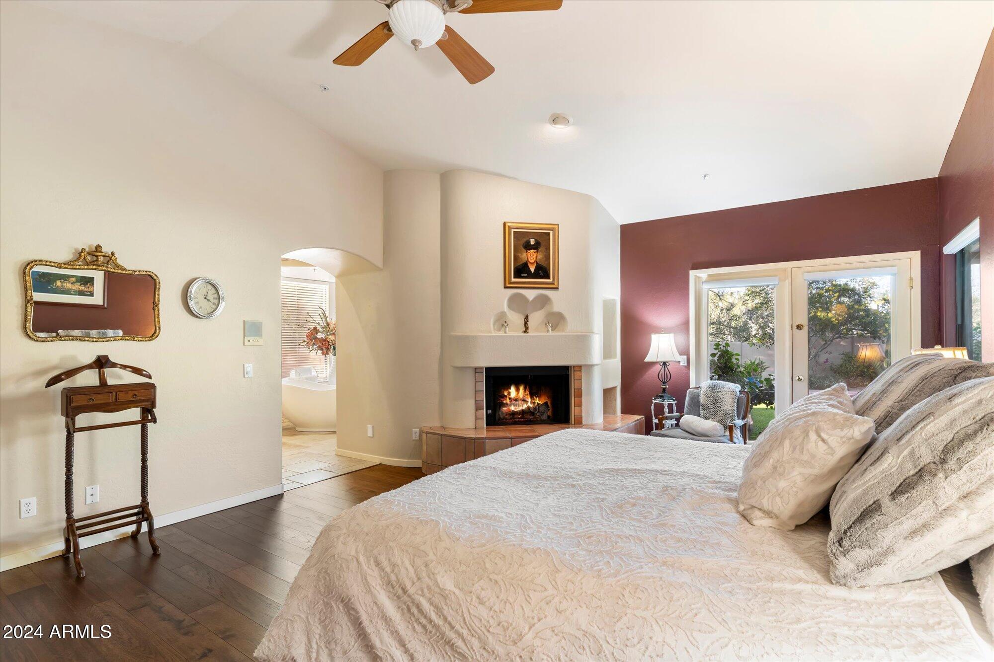 25255 North Ranch Gate Road Scottsdale, AZ 85255 - Photo 27 of 68 a bedroom with a bed and a fireplace