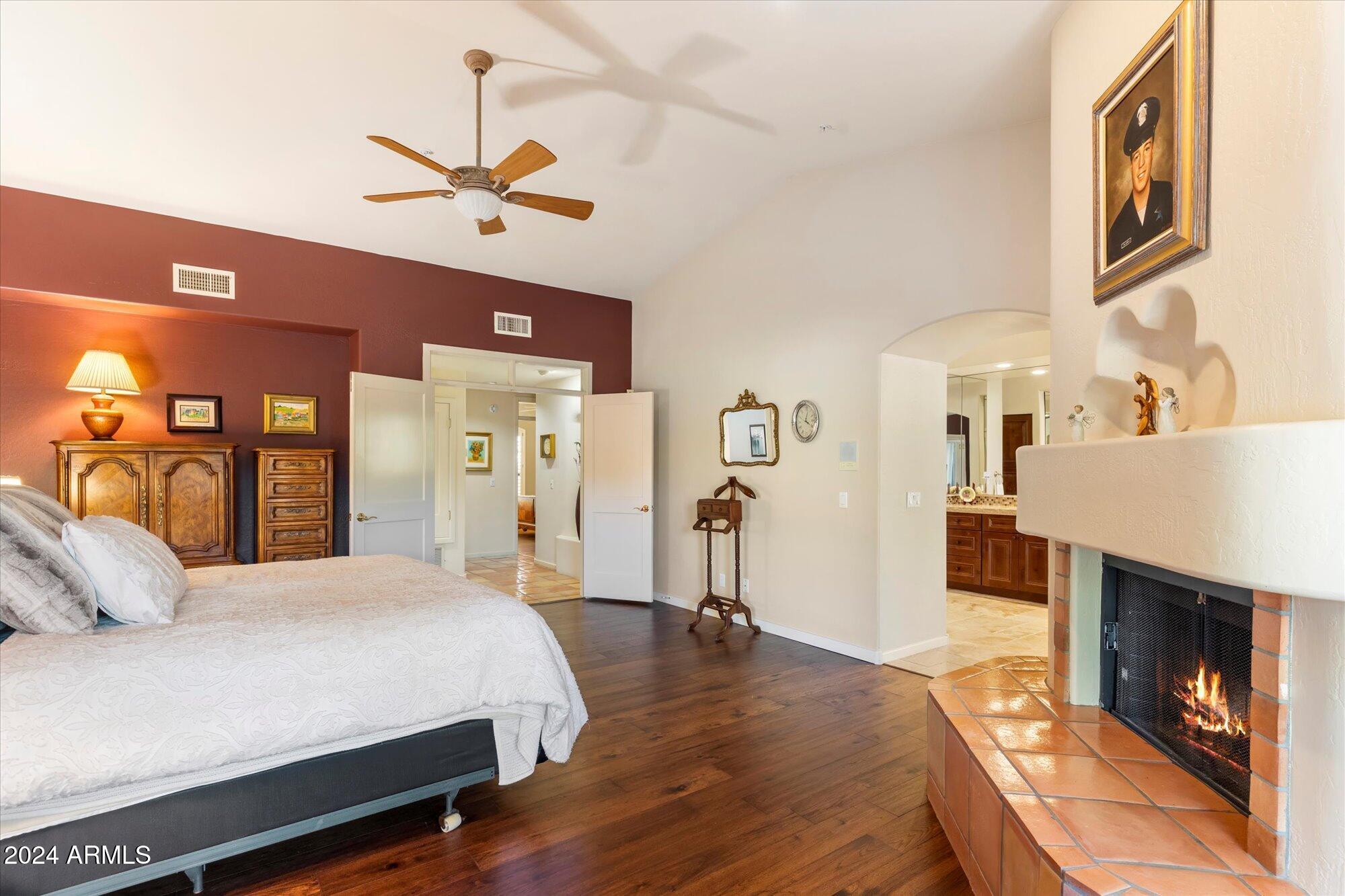25255 North Ranch Gate Road Scottsdale, AZ 85255 - Photo 28 of 68 a bedroom with a bed and a fireplace