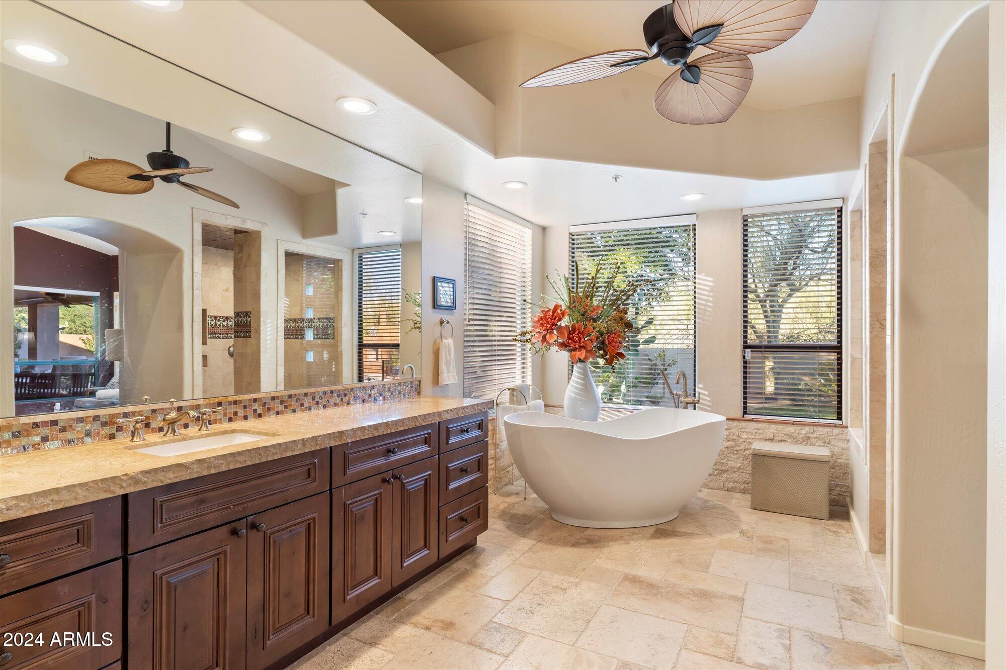 25255 North Ranch Gate Road Scottsdale, AZ 85255 - Photo 31 of 68 a spacious bathroom with a tub sink and mirror