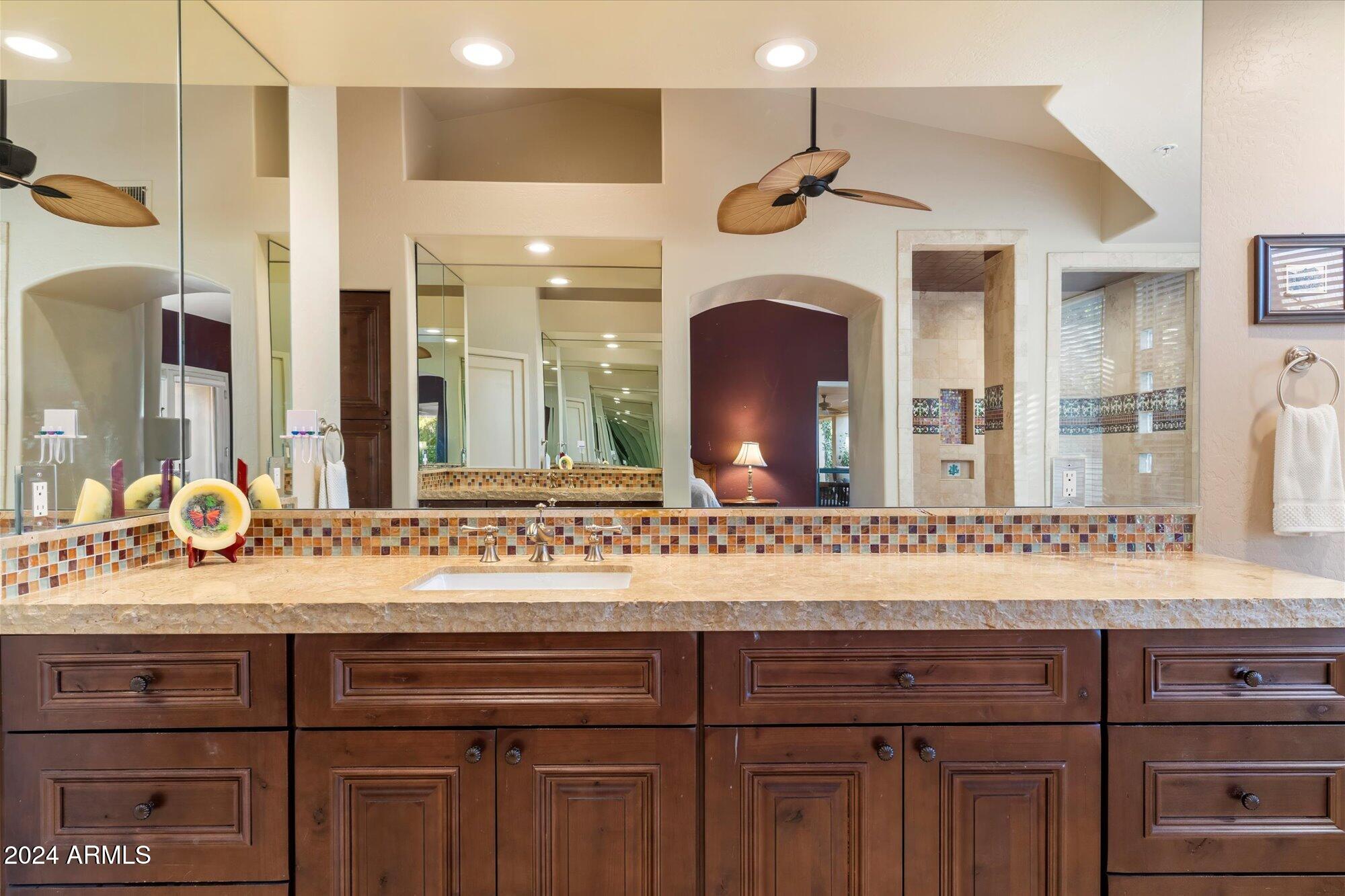 25255 North Ranch Gate Road Scottsdale, AZ 85255 - Photo 32 of 68 a bathroom with a sink vanity and a mirror