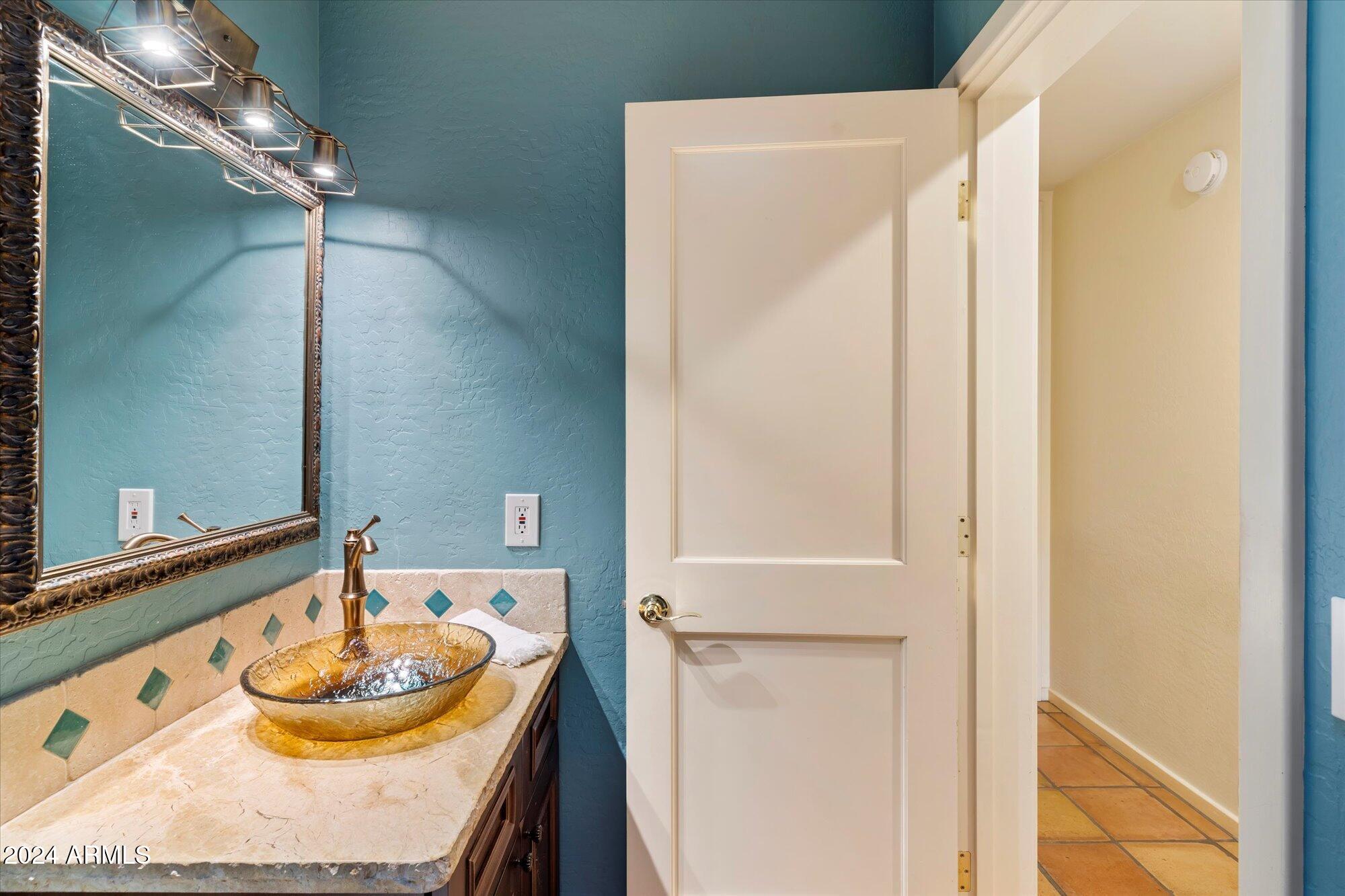 25255 North Ranch Gate Road Scottsdale, AZ 85255 - Photo 39 of 68 a bathroom with a granite countertop sink and a mirror