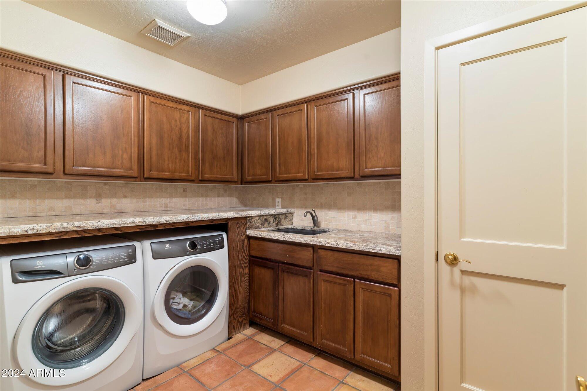 25255 North Ranch Gate Road Scottsdale, AZ 85255 - Photo 41 of 68 a kitchen with a sink a stove and cabinets