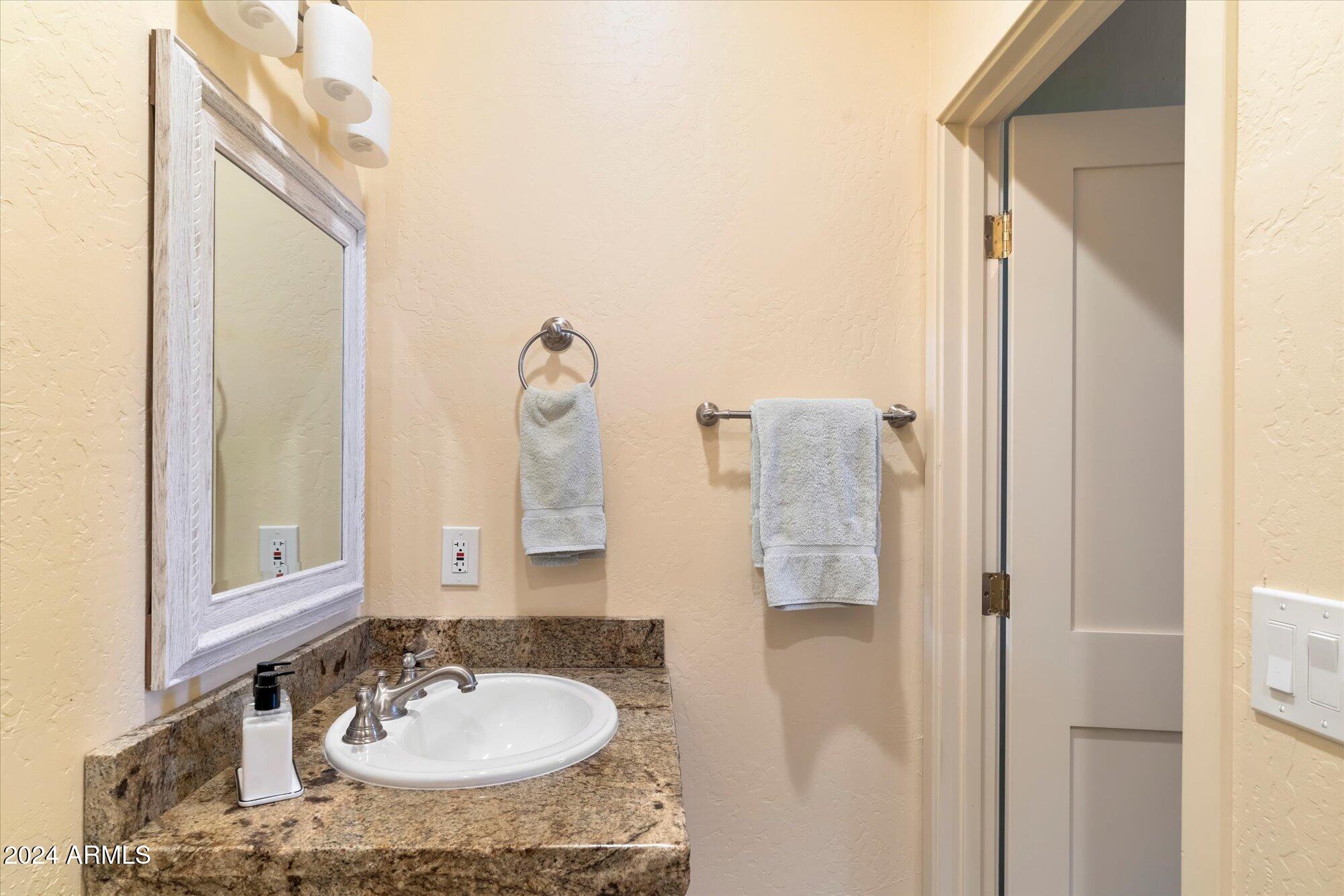 25255 North Ranch Gate Road Scottsdale, AZ 85255 - Photo 44 of 68 a bathroom with a sink vanity and a mirror