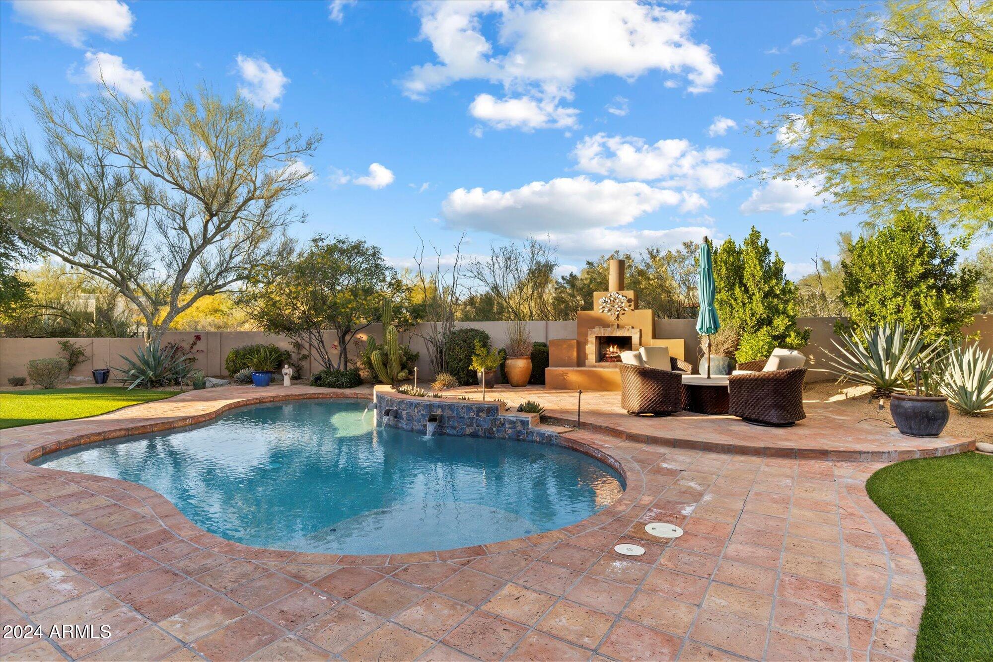 25255 North Ranch Gate Road Scottsdale, AZ 85255 - Photo 49 of 68 a view of a swimming pool with a lounge chairs