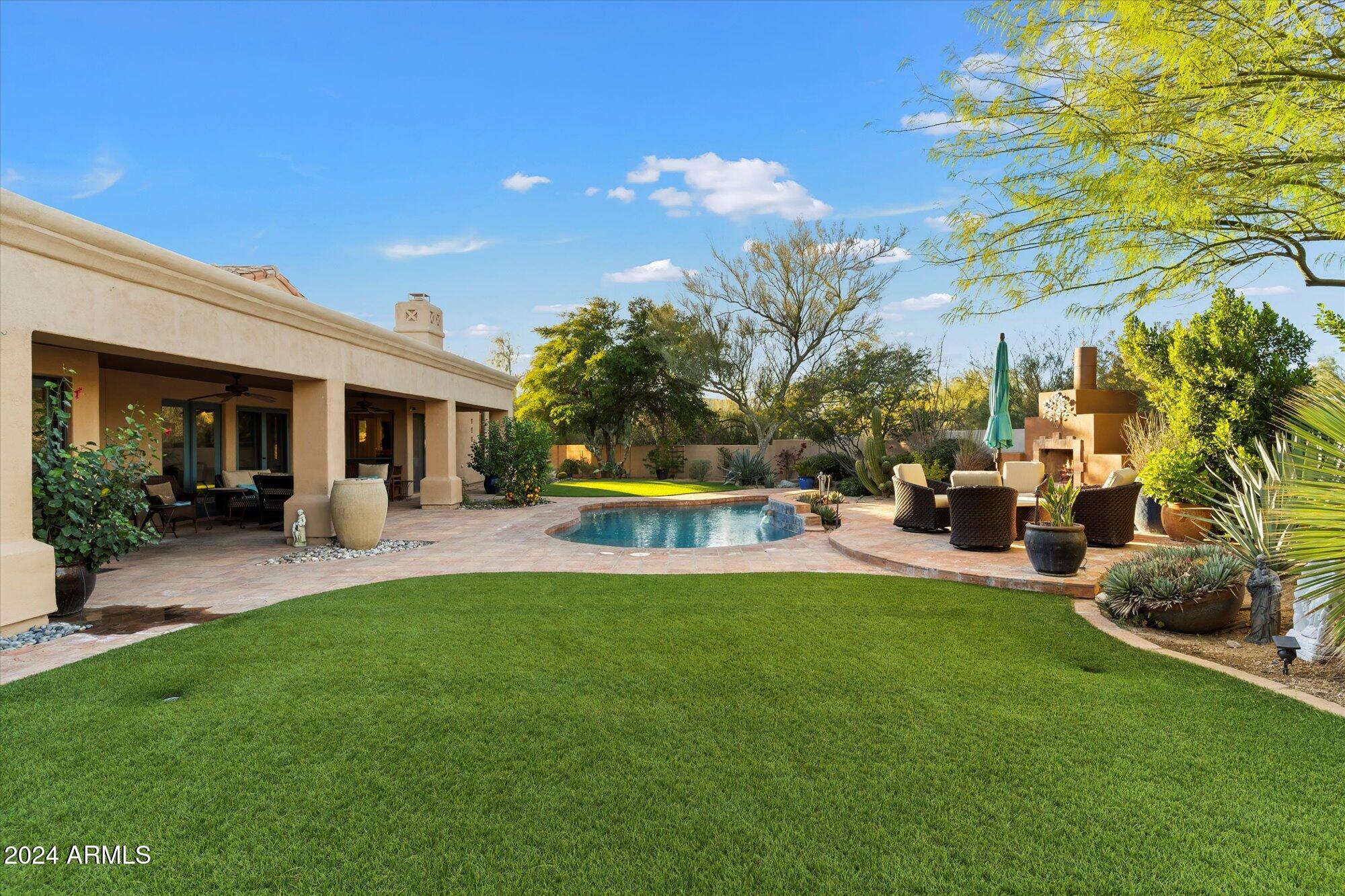 25255 North Ranch Gate Road Scottsdale, AZ 85255 - Photo 51 of 68 a view of a house with a backyard porch and sitting area