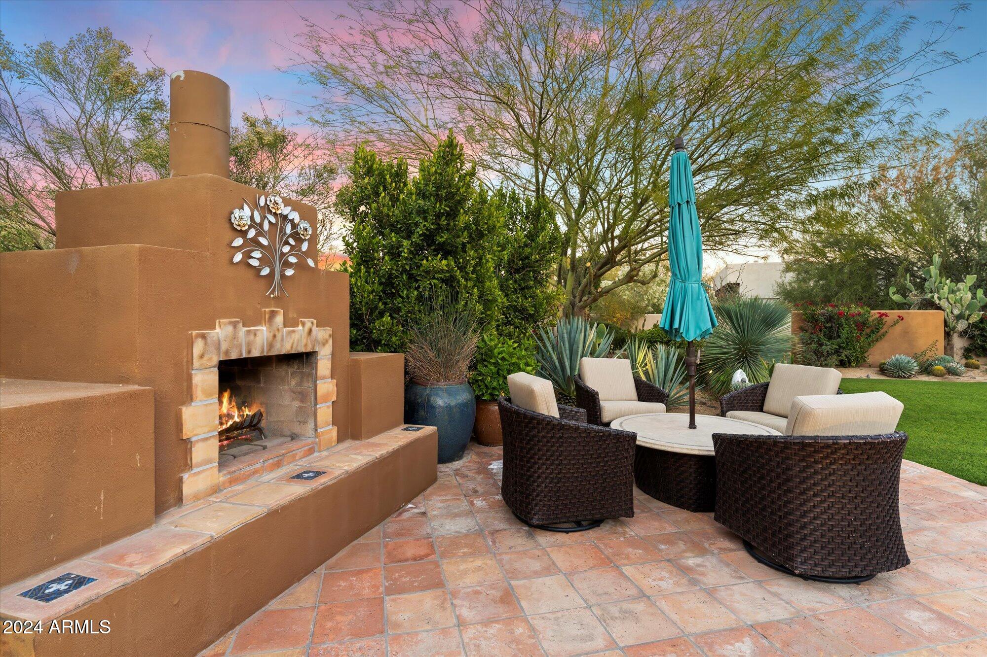 25255 North Ranch Gate Road Scottsdale, AZ 85255 - Photo 55 of 68 a view of a patio with couches chairs and a fire pit