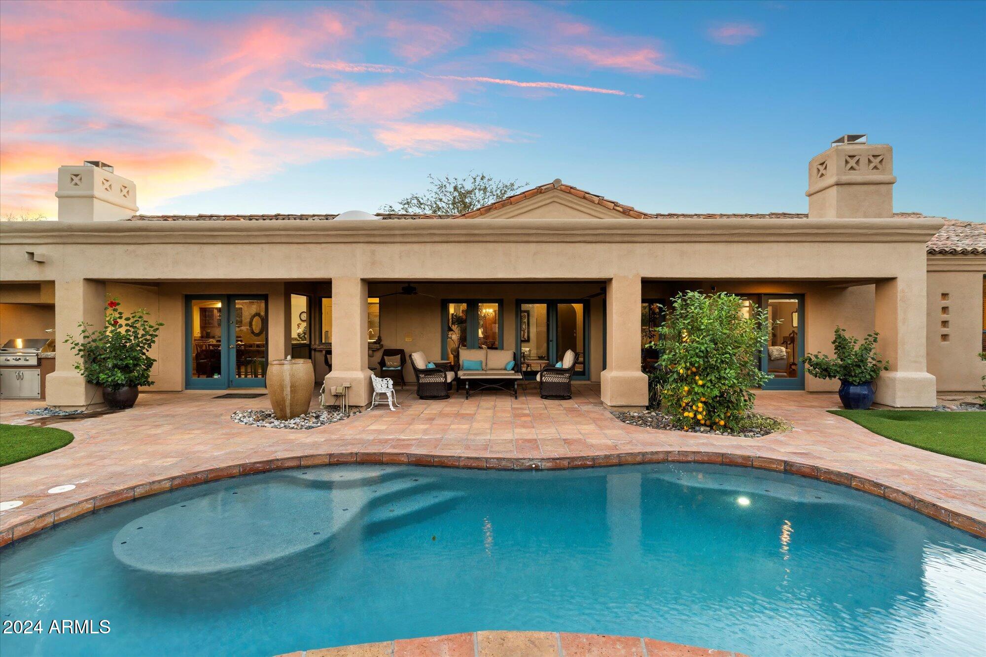 25255 North Ranch Gate Road Scottsdale, AZ 85255 - Photo 56 of 68 a view of a house with swimming pool and sitting area
