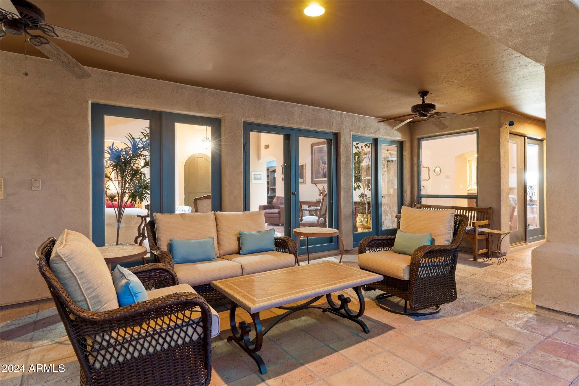 25255 North Ranch Gate Road Scottsdale, AZ 85255 - Photo 64 of 68 a living room with furniture a flat screen tv and a large window