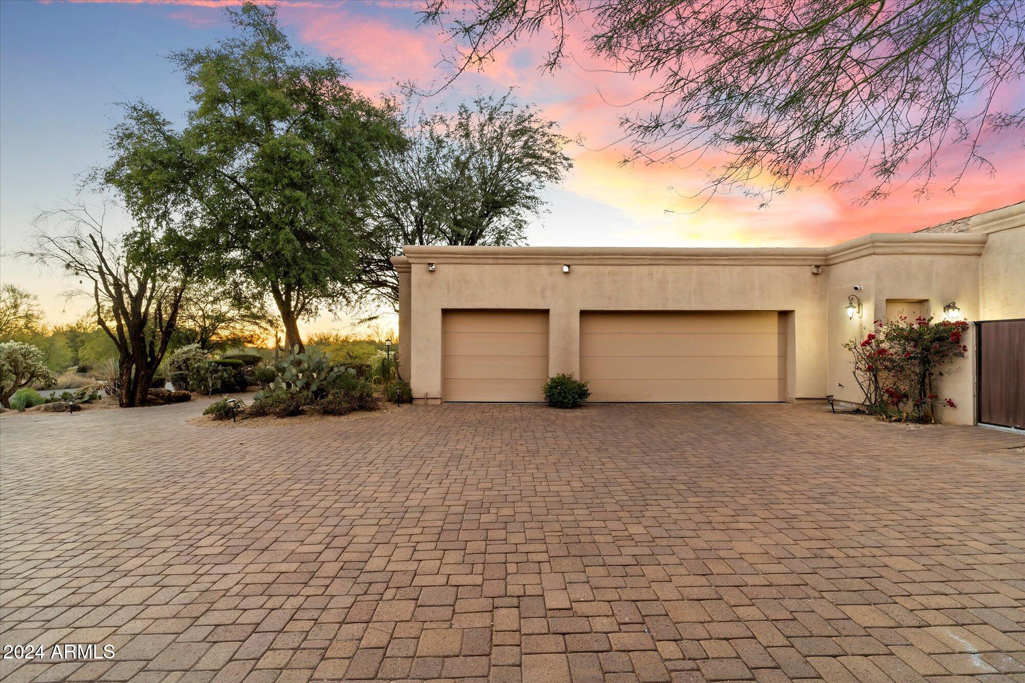 25255 North Ranch Gate Road Scottsdale, AZ 85255 - Photo 68 of 68 a front view of a house with a yard and garage