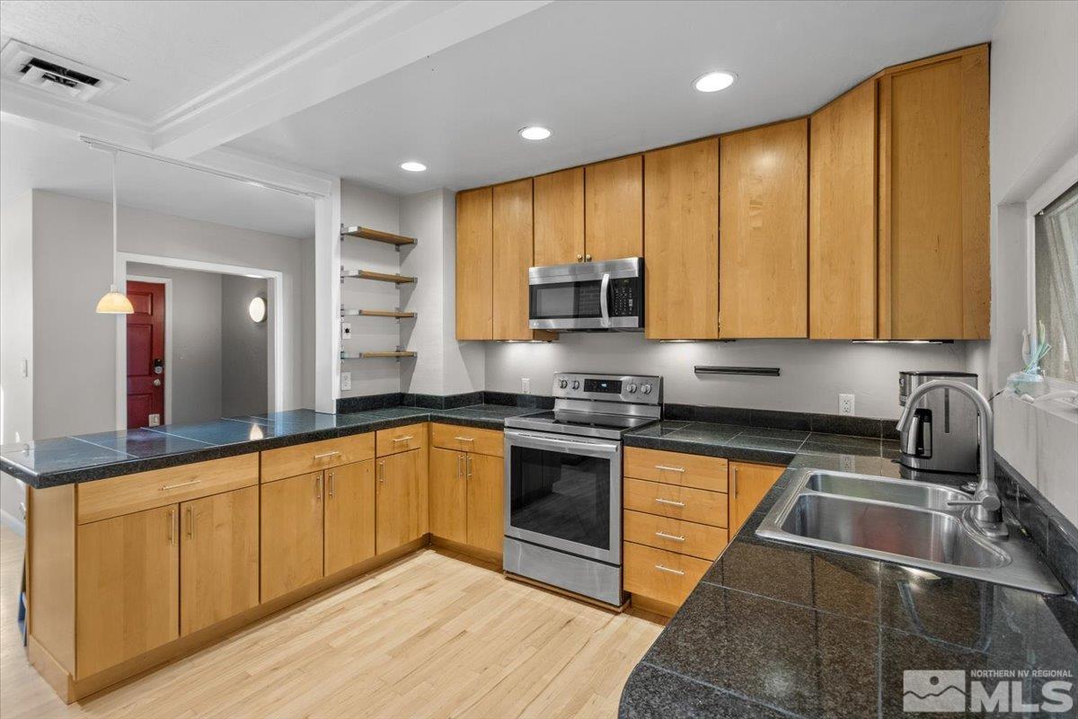1248 Bon Rea Way Reno, NV 89503 - Photo 8 of 39 a kitchen with stainless steel appliances granite countertop a sink a stove and cabinets
