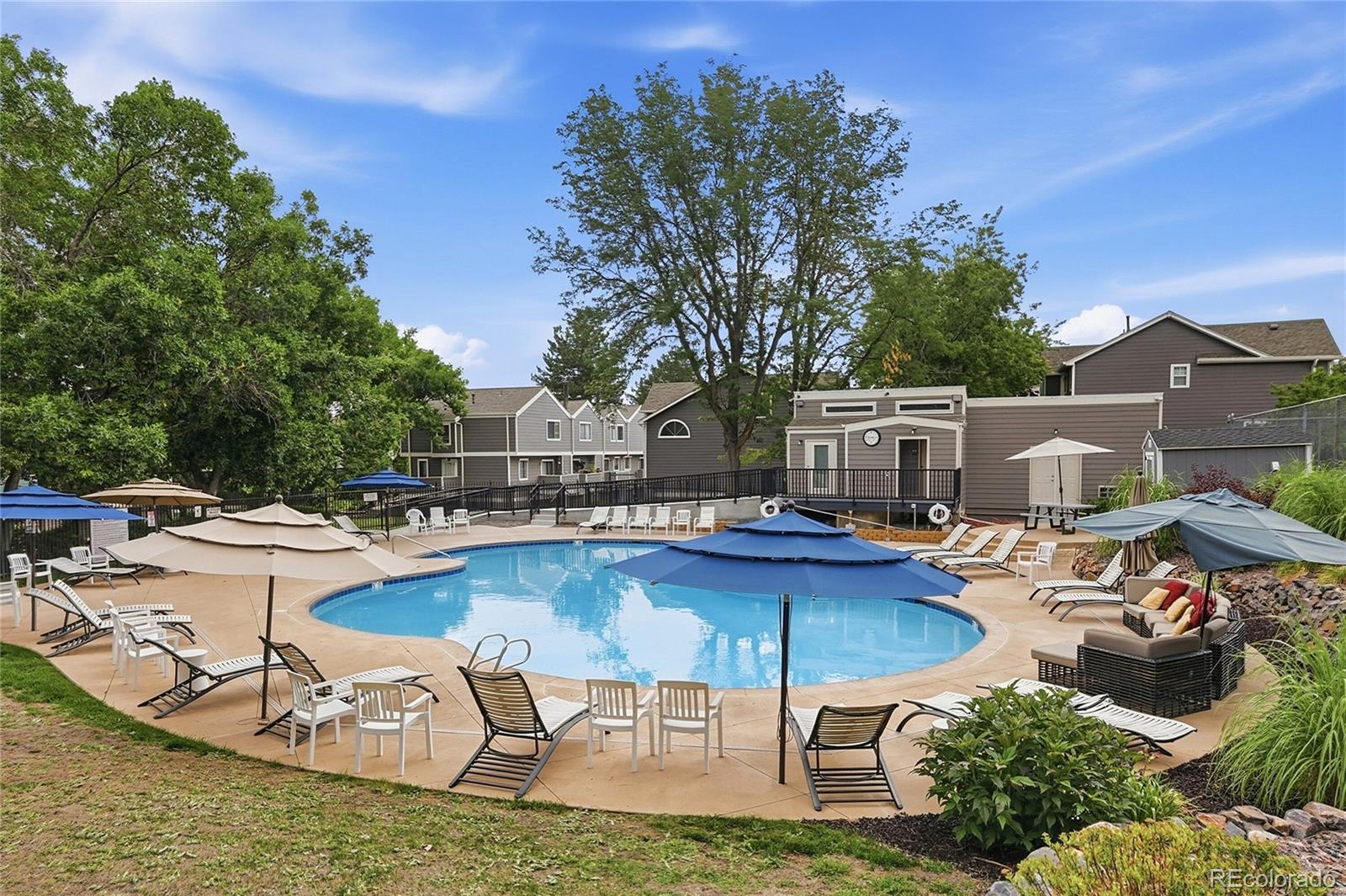 6855 West 84th Way, Unit 32 Arvada, CO 80003 - Photo 25 of 37 a view of a swimming pool with chairs