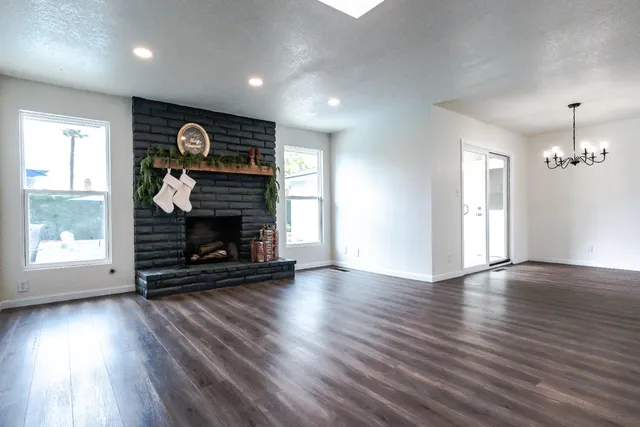 a living room with wooden floors and a fireplace