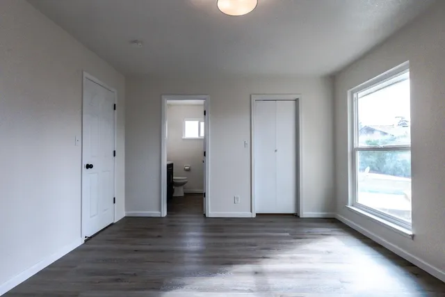 a bathroom with a double vanity sink toilet and a mirror