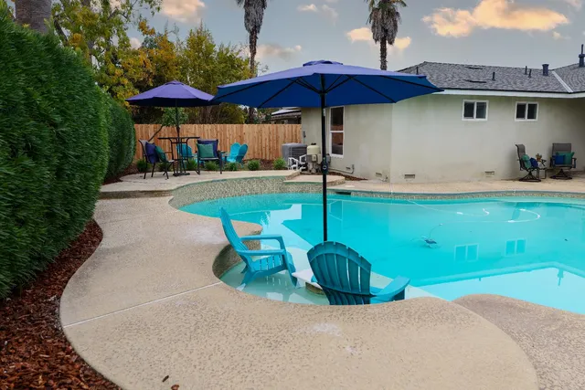 a view of a backyard with sitting area