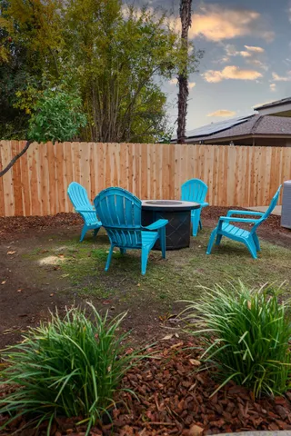 a backyard of a house with table and chairs
