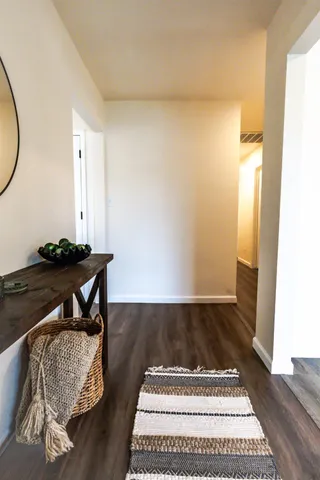 a view of a hall way with furniture and rug