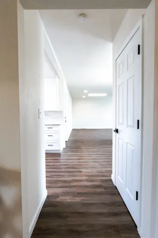 a kitchen with granite countertop white cabinets stainless steel appliances and sink