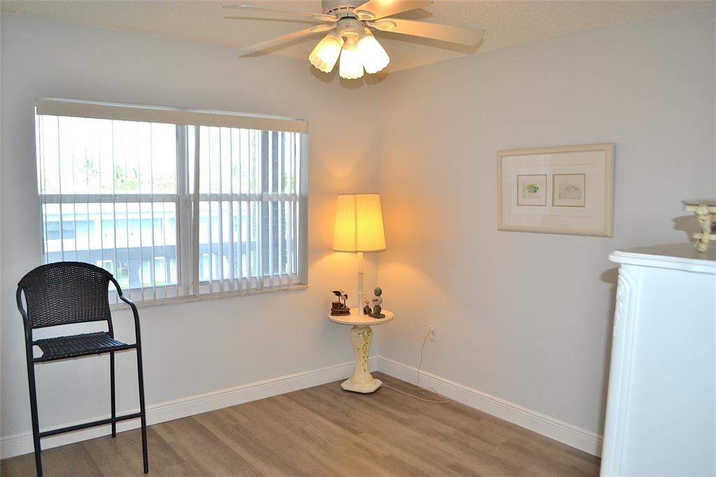 9856 Marina Boulevard, Unit 1337 Boca Raton, FL 33428 - Photo 11 of 21 a room with a window and wooden floor