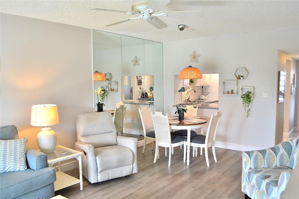 9856 Marina Boulevard, Unit 1337 Boca Raton, FL 33428 - Photo 15 of 21 a living room with furniture and a chandelier