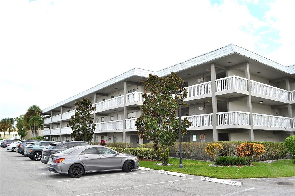 9856 Marina Boulevard, Unit 1337 Boca Raton, FL 33428 - Photo 21 of 21 a view of a cars park in front of a building