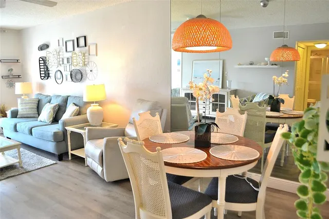 a dining room with furniture and wooden floor