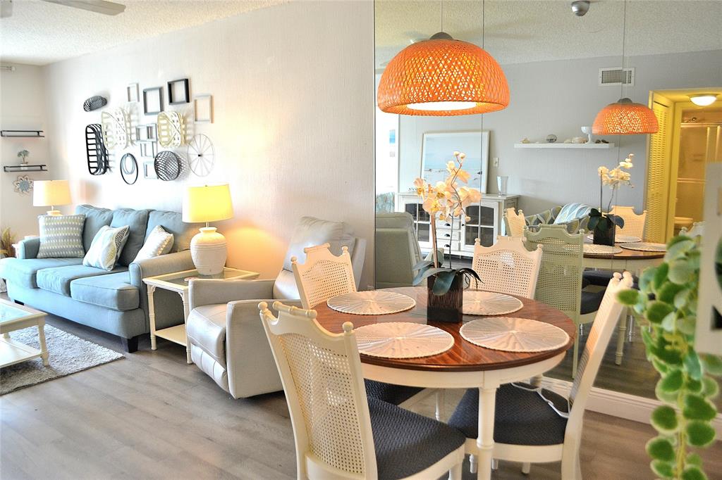 9856 Marina Boulevard, Unit 1337 Boca Raton, FL 33428 - Photo 5 of 21 a dining room with furniture and wooden floor