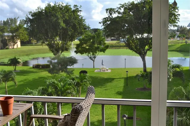 a view of a room and balcony with furniture