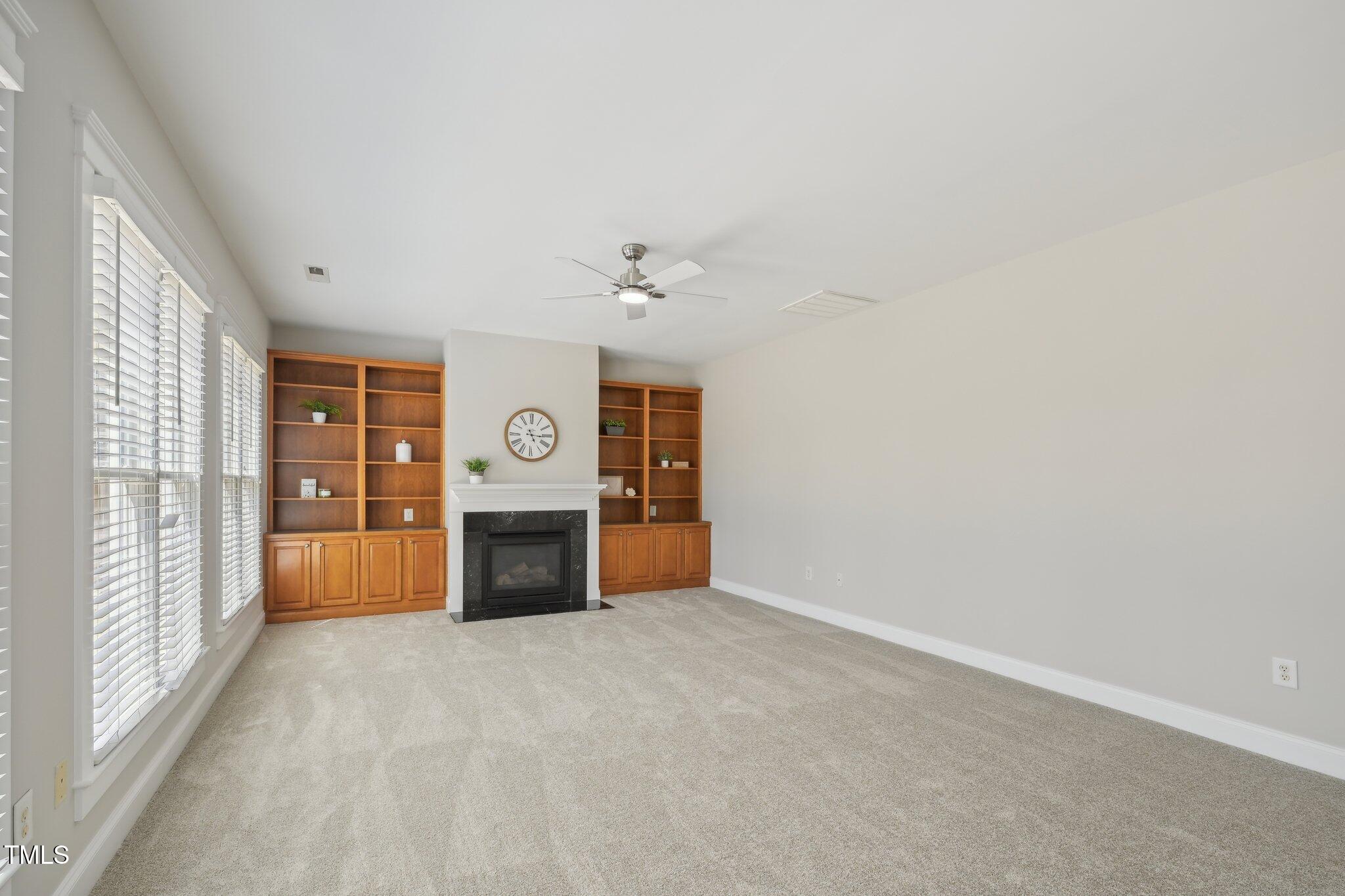 304 Frontgate Drive Cary, NC 27519 - Photo 11 of 41 a view of an empty room with a fireplace and a window