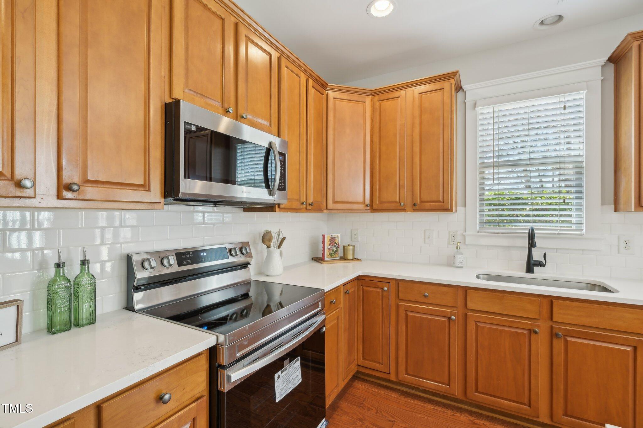 304 Frontgate Drive Cary, NC 27519 - Photo 13 of 41 a kitchen with stainless steel appliances granite countertop a sink a stove and cabinets