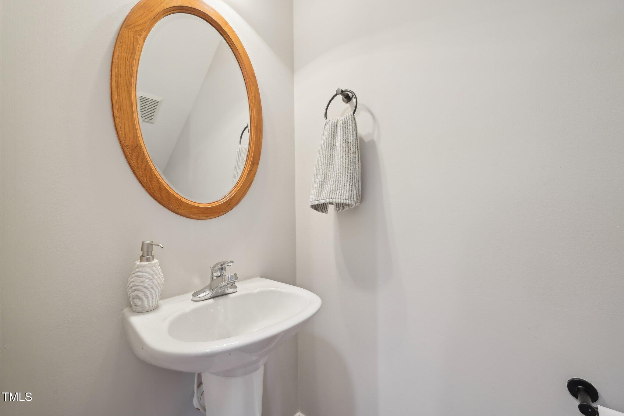 304 Frontgate Drive Cary, NC 27519 - Photo 17 of 41 a bathroom with a sink and a mirror