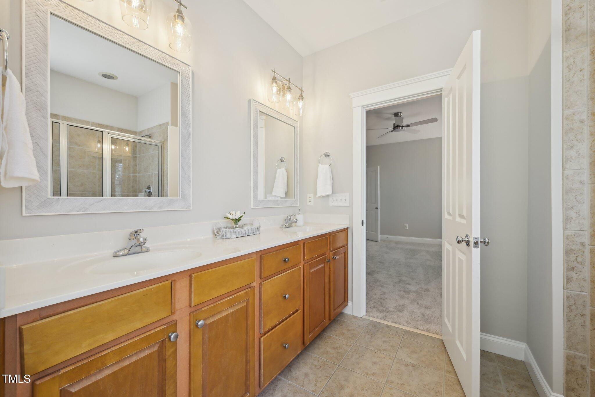 304 Frontgate Drive Cary, NC 27519 - Photo 23 of 41 a bathroom with double vanity sink and a mirror
