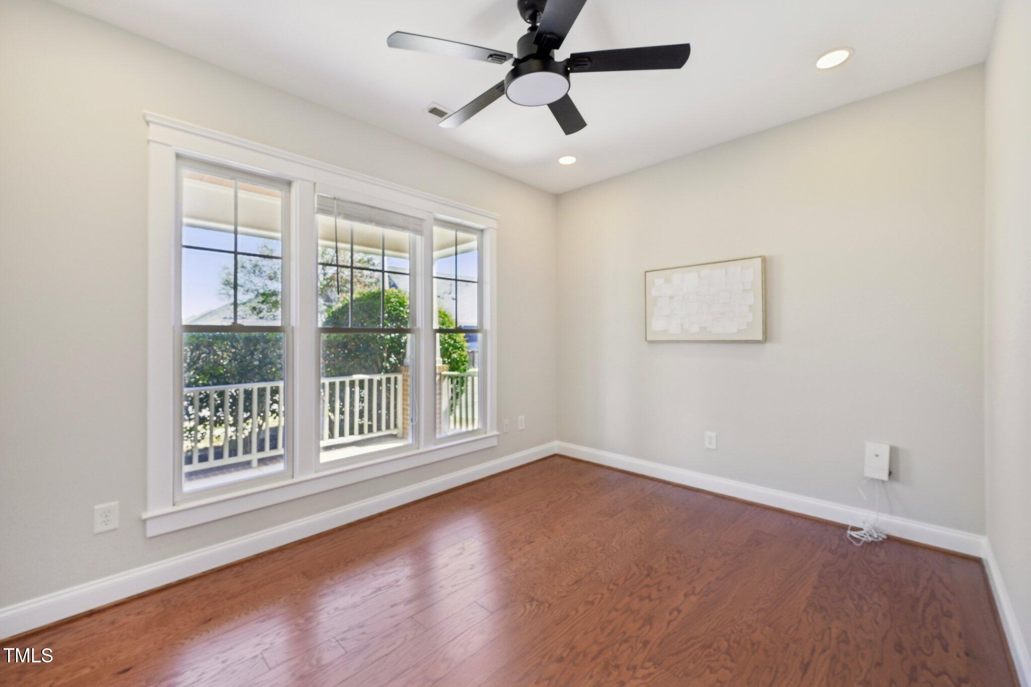304 Frontgate Drive Cary, NC 27519 - Photo 5 of 41 a view of an empty room with a window and wooden floor