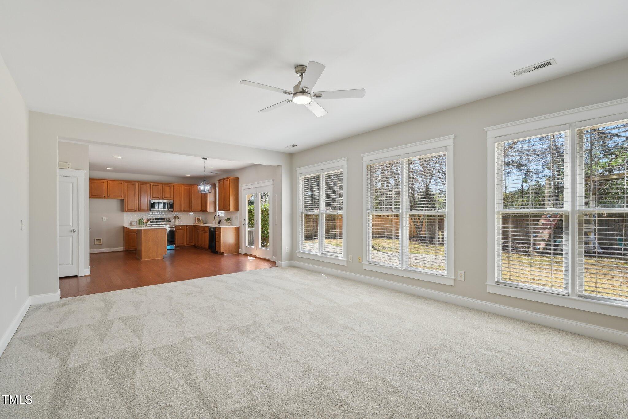 304 Frontgate Drive Cary, NC 27519 - Photo 9 of 41 a view of a livingroom with furniture hardwood floor ceiling fan and windows
