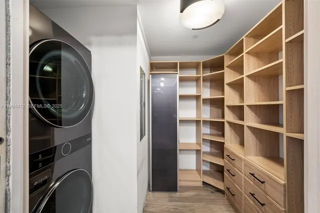 a bedroom with a bed a mirror and lamp