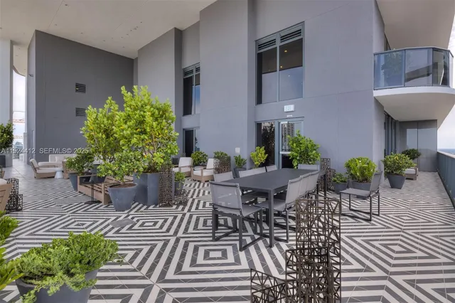 a view of a building with a potted plant and stairs