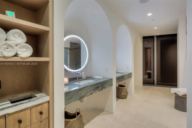 a living room with furniture kitchen view and a large window