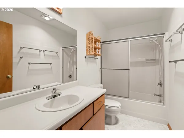 a bathroom with a sink toilet a mirror and shower