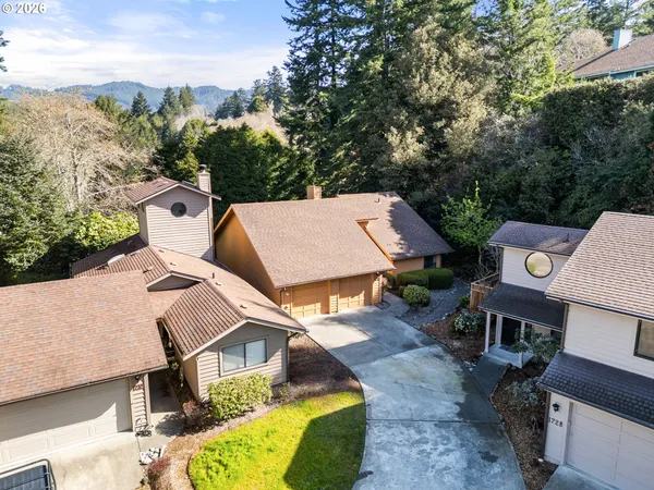 an aerial view of a house with a yard