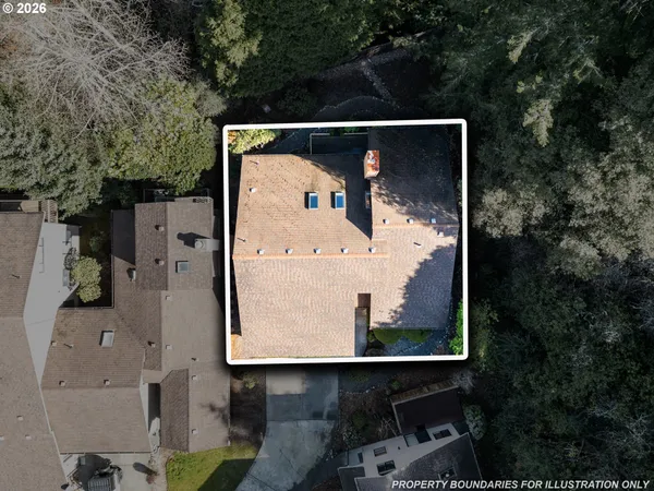 an aerial view of a house with a yard and large tree