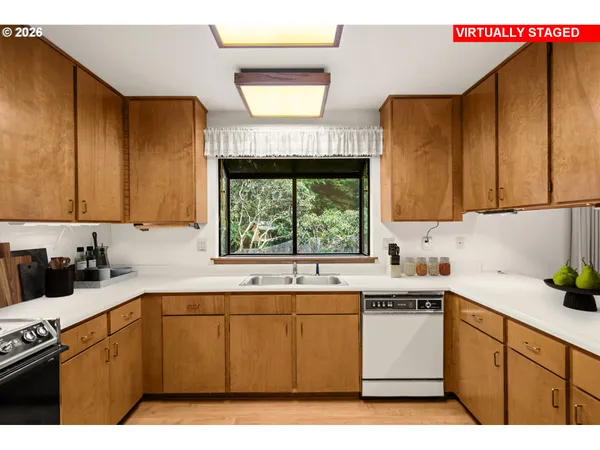 a kitchen with a sink cabinets and window