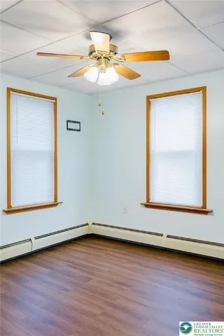 a view of a small space with wooden floor and a window