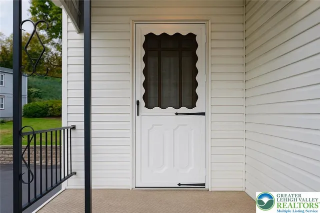 a view of a door and brick wall