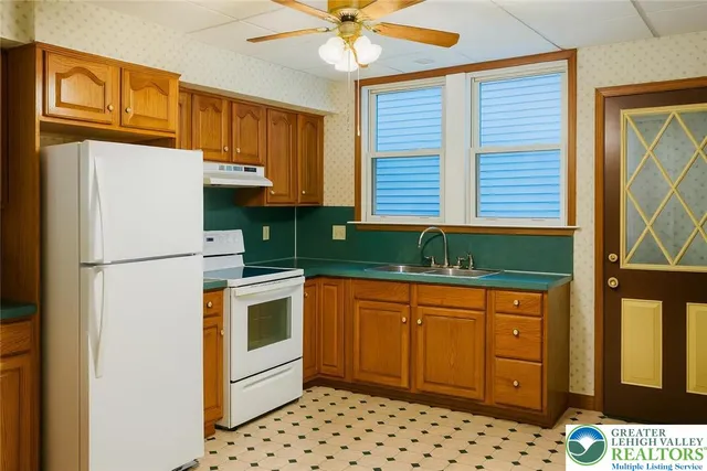 a kitchen with stainless steel appliances granite countertop a refrigerator sink and cabinets