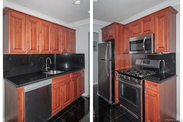 a kitchen with granite countertop a stove top oven microwave and refrigerator