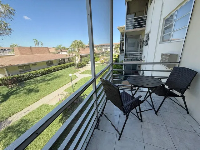 a two chairs sitting in the back yard of the house
