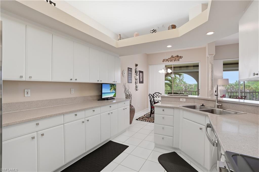 10871 Crooked River Road, Unit 202 Estero, FL 34135 - Photo 14 of 46 a kitchen with sink and cabinets