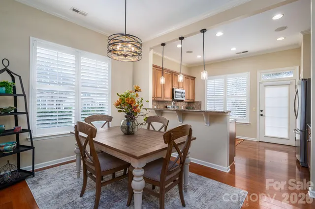 a view of a dining room with furniture window and wooden floor