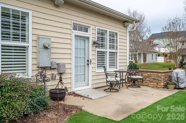 a view of backyard of house with outdoor seating