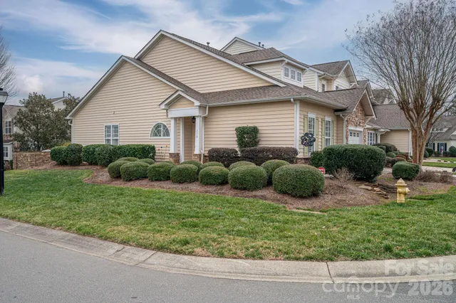 a view of a house with a backyard and plants